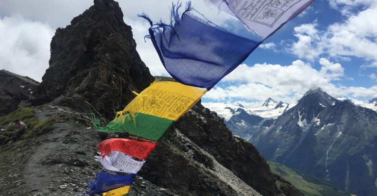 Classic Haute Route - Tibetan prayer flags blowing with the wind on the col de Torrent